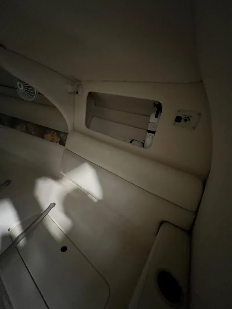 Slide: The Image of Interior of a 1997 Donzi 27 ZX boat, featuring white seating and storage compartments. - 14