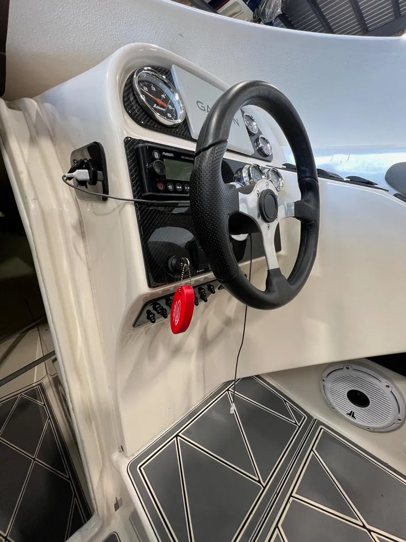 Slide: The Image of 1997 Donzi 27 ZX boat interior dashboard with steering wheel and controls. - 15