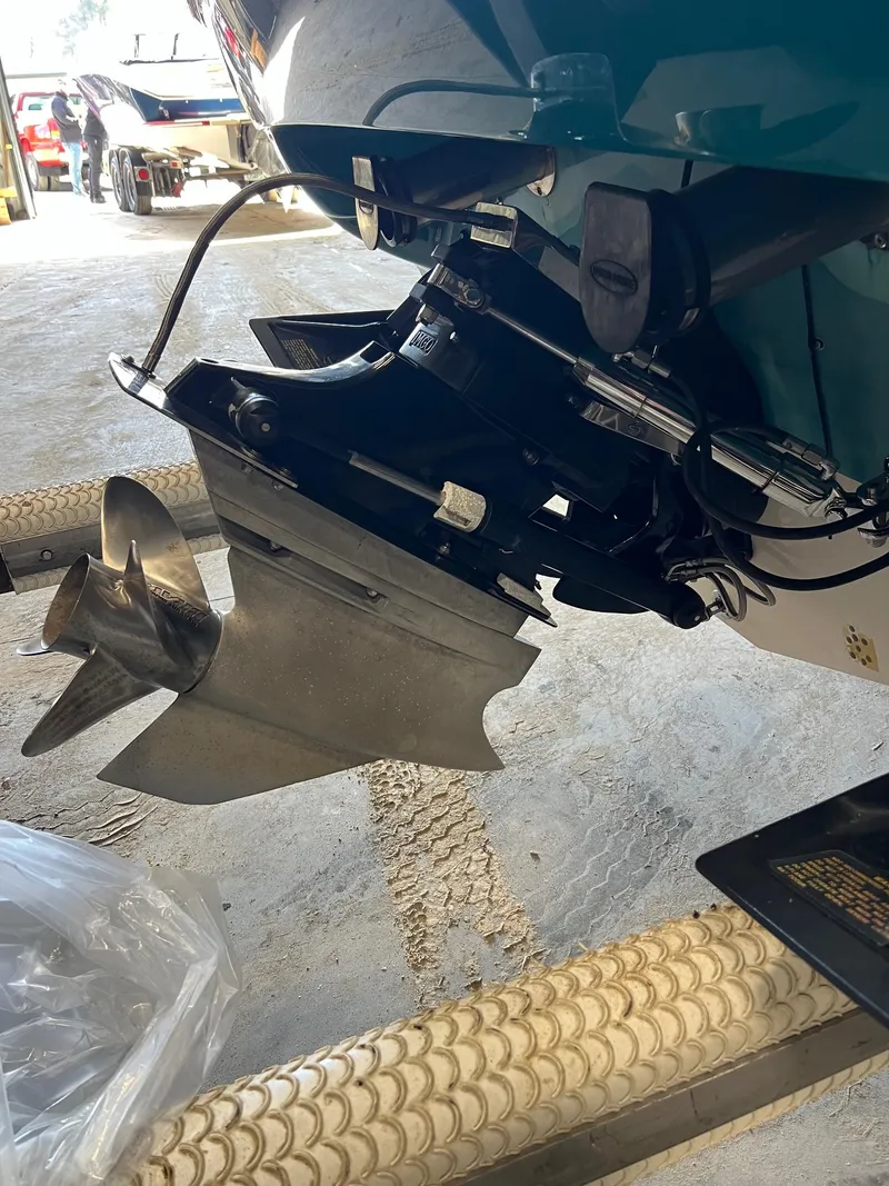 Slide: The Image of 1997 Donzi 27 ZX boat propeller and stern drive in a garage setting. - 7