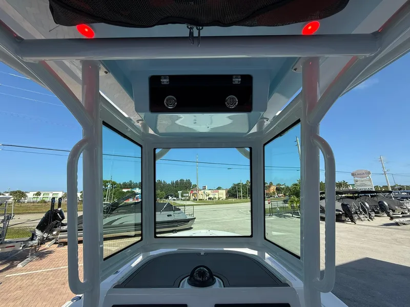Slide: The Image of 2024 Caymas 26 HB boat interior view with windows and overhead console. - 13