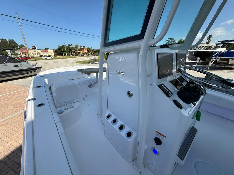 Slide: The Image of 2024 Caymas 26 HB boat interior with modern console and steering wheel. - 18