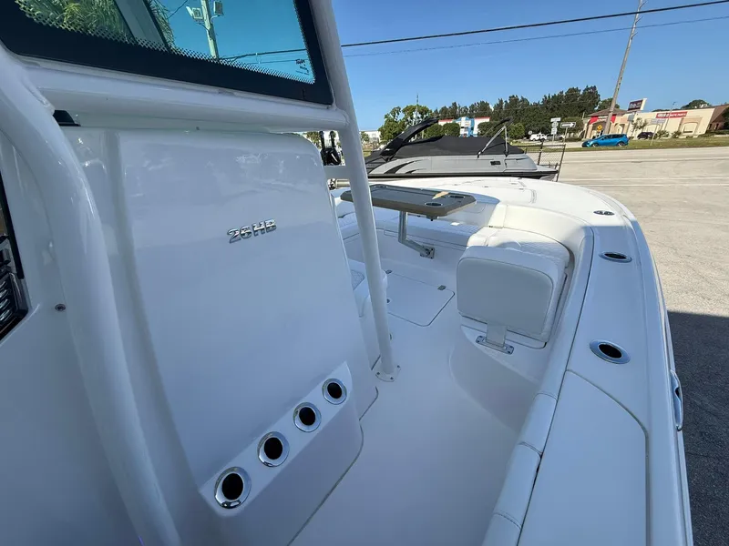 Slide: The Image of 2024 Caymas 26 HB boat, sleek white deck, modern design, outdoor setting. - 19