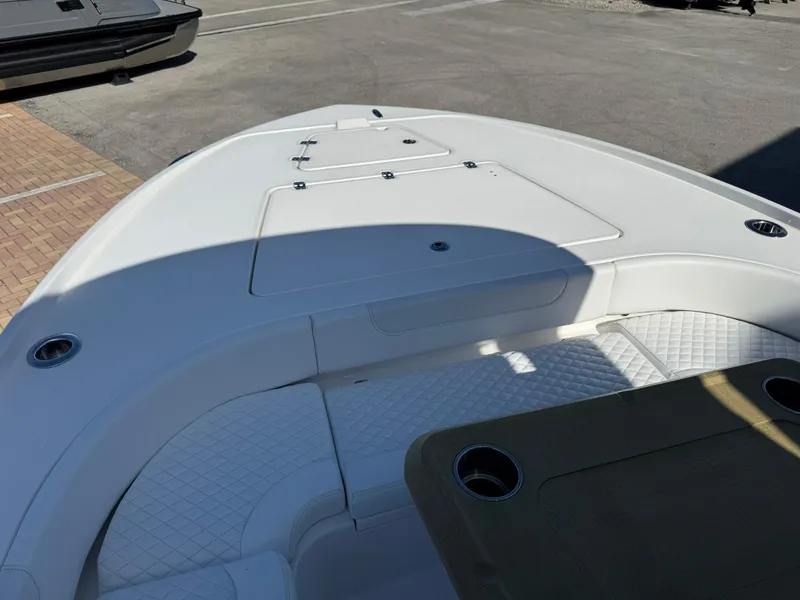 Slide: The Image of 2024 Caymas 26 HB boat deck with seating and storage compartments. - 24