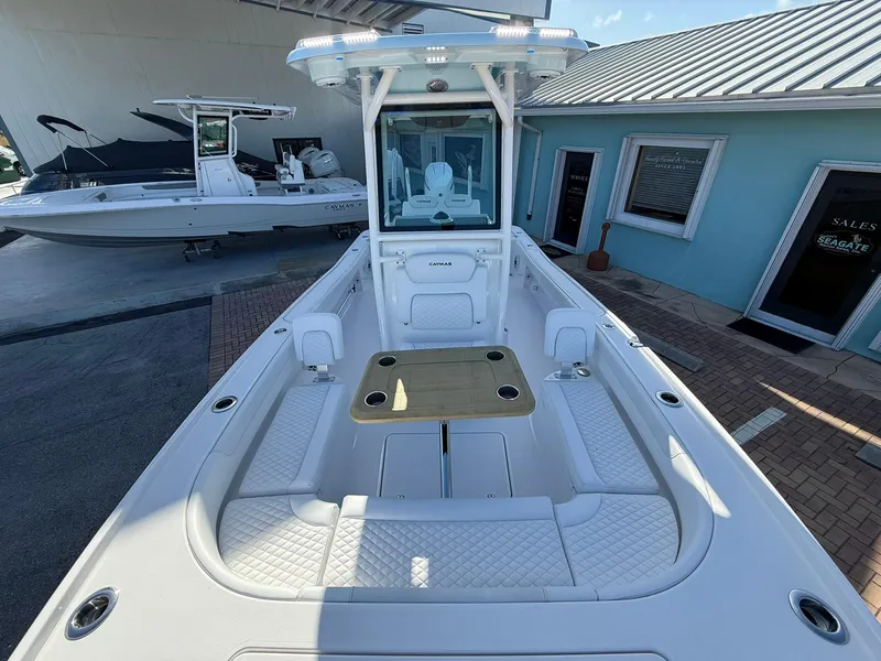 Slide: The Image of 2024 Caymas 26 HB boat with spacious deck and seating, displayed outdoors. - 26