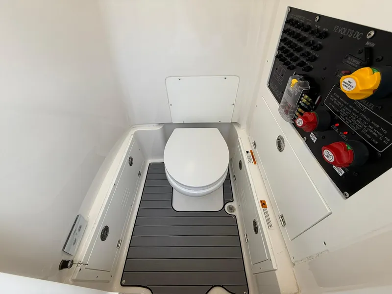 Slide: The Image of 2024 Caymas 26 HB boat interior with toilet and control panel. - 29