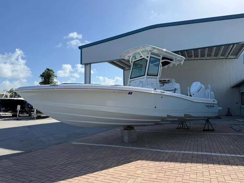 Slide: The Image of 2024 Caymas 26 HB boat displayed outdoors on a sunny day. - 4