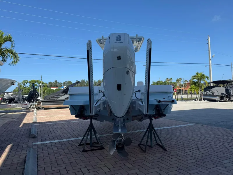 Slide: The Image of 2024 Caymas 26 HB boat displayed on stands in a parking area. - 5