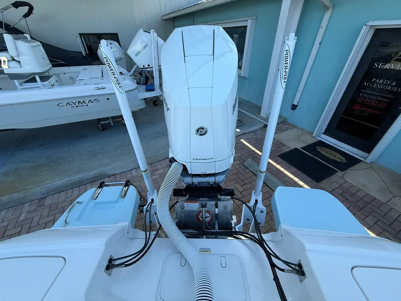 Slide: The Image of 2024 Caymas 26 HB boat with powerful outboard motor and dual power poles. - 6
