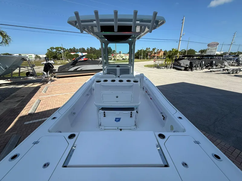 Slide: The Image of 2024 Caymas 26 HB boat with spacious deck and modern design in a sunny outdoor setting. - 7