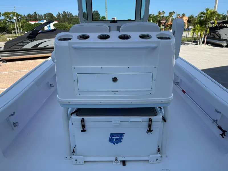 Slide: The Image of 2024 Caymas 26 HB boat interior with storage and cooler on deck. - 9