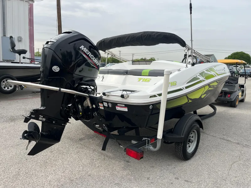 Slide: The Image of 2021 Tahoe T16 boat with Mercury outboard motor on trailer, parked outdoors. - 10