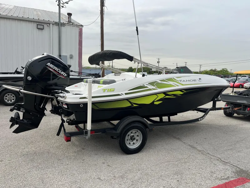 Slide: The Image of 2021 Tahoe T16 boat with Mercury engine on trailer, parked outdoors. - 11
