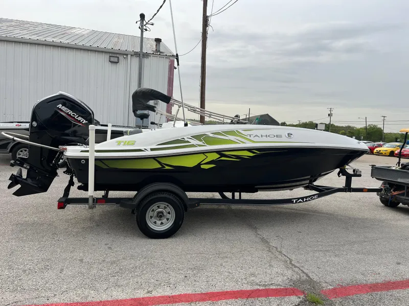 Slide: The Image of 2021 Tahoe T16 boat with Mercury engine on trailer, parked outdoors. - 12