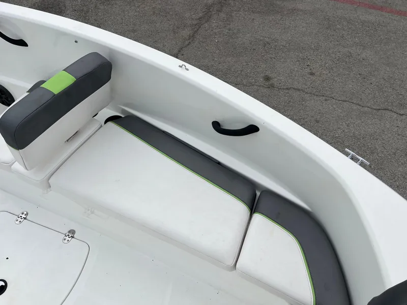 Slide: The Image of 2021 Tahoe T16 boat interior with gray and green cushioned seating. - 17