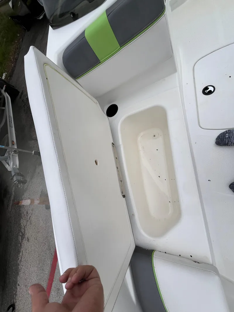 Slide: The Image of 2021 Tahoe T16 boat interior with open storage compartment and seating. - 18