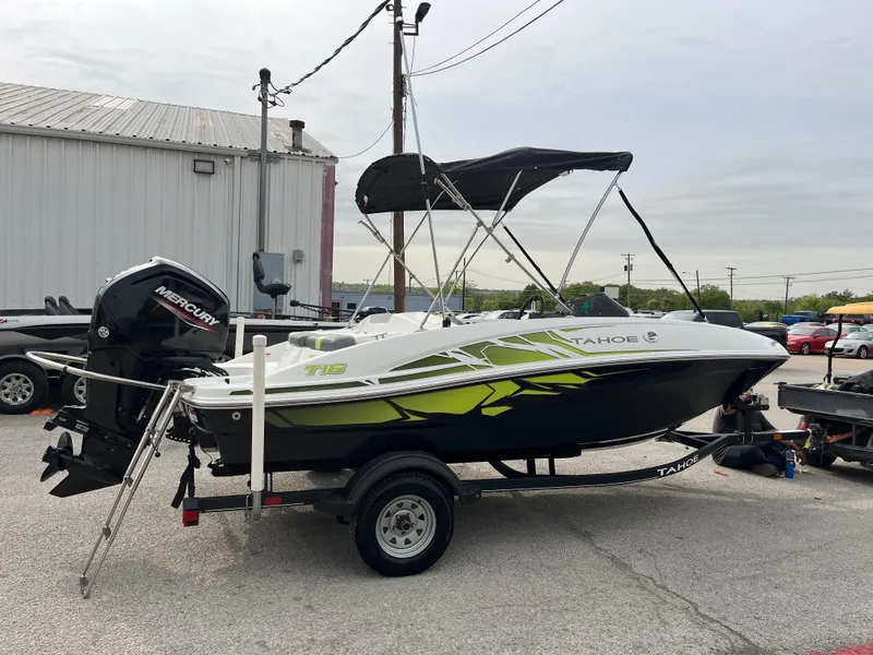 Slide: The Image of 2021 Tahoe T16 boat with canopy and Mercury outboard motor on trailer. - 28
