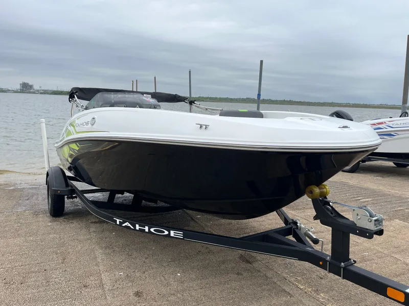 Slide: The Image of 2021 Tahoe T16 boat on trailer by waterfront, overcast sky. - 30