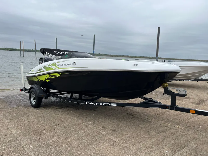 Slide: The Image of 2021 Tahoe T16 boat on trailer by the water, overcast sky. - 32