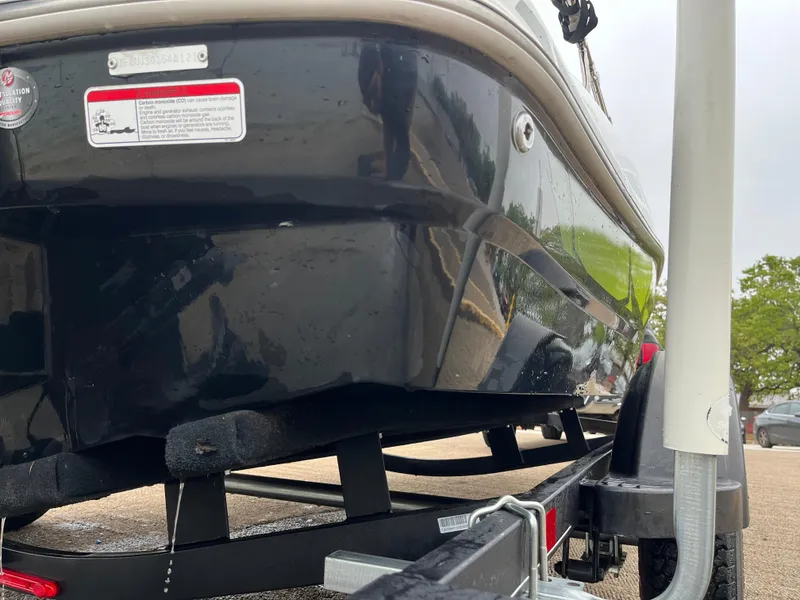 Slide: The Image of 2021 Tahoe T16 boat on trailer, close-up view of hull and trailer details. - 35