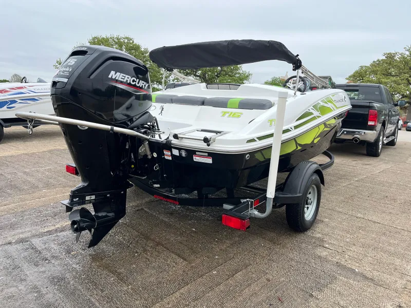 Slide: The Image of 2021 Tahoe T16 boat with Mercury engine on trailer, parked outdoors. - 36