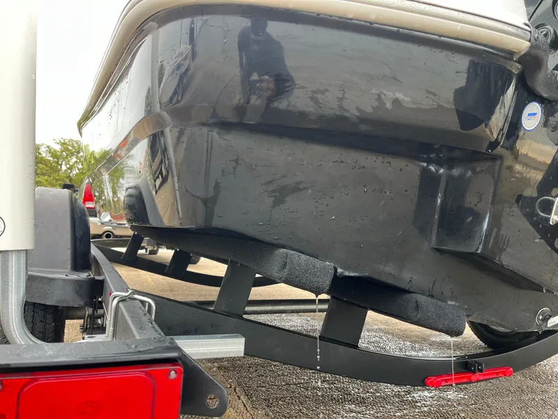 Slide: The Image of 2021 Tahoe T16 boat on trailer, rear view, showing hull and trailer details. - 39