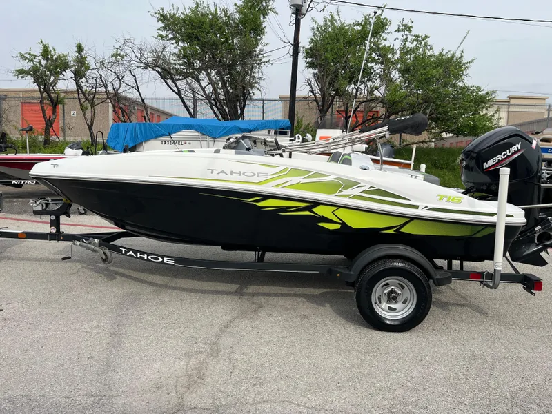 Slide: The Image of 2021 Tahoe T16 boat with trailer, featuring sleek design and vibrant green accents. - 4
