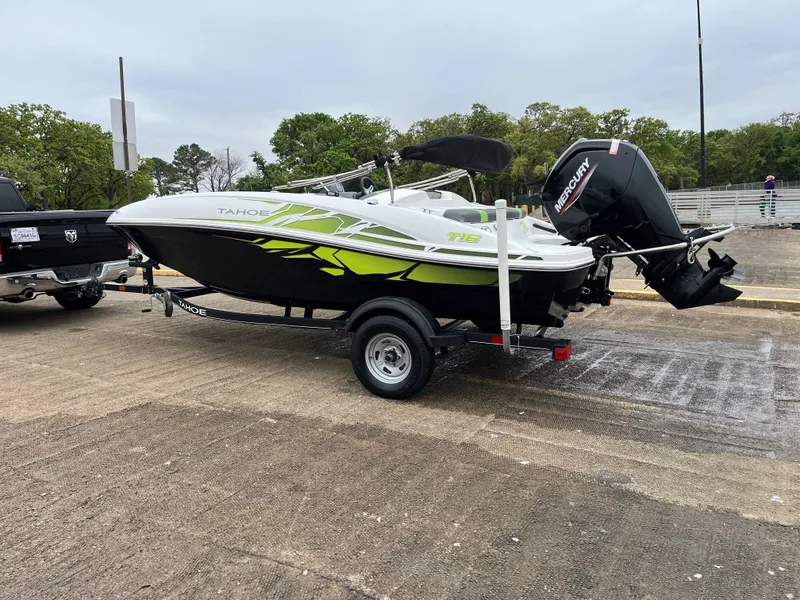 Slide: The Image of 2021 Tahoe T16 boat on trailer with Mercury outboard motor, parked outdoors. - 41