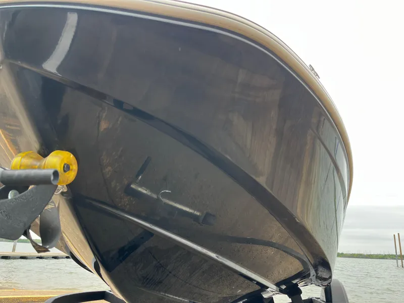 Slide: The Image of 2021 Tahoe T16 boat on trailer, close-up of hull, dockside view. - 43