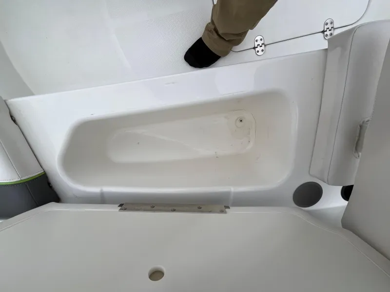 Slide: The Image of 2021 Tahoe T16 boat interior with storage compartment and foot visible. - 49