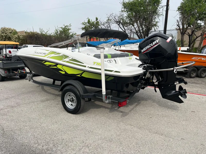 Slide: The Image of 2021 Tahoe T16 boat with Mercury engine on trailer, parked outdoors. - 5