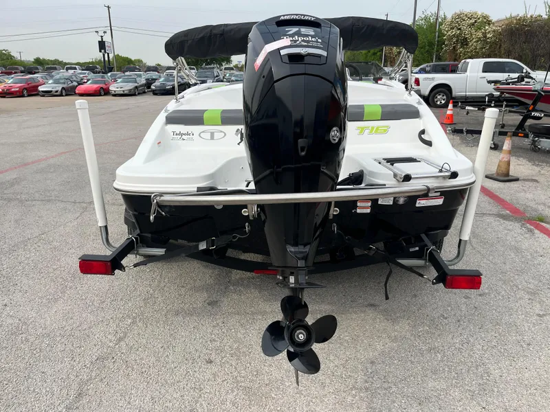 Slide: The Image of 2021 Tahoe T16 boat with outboard motor in a parking lot. - 7