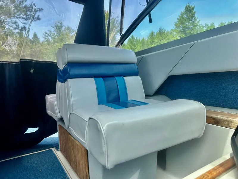 Slide: The Image of Interior of 1988 Sea Ray 230 Cuddy with blue and white seating. - 5