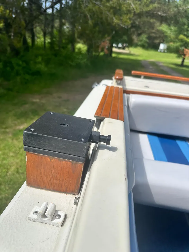 Slide: The Image of 1988 Sea Ray 230 Cuddy boat interior with wooden trim and seating detail. - 7