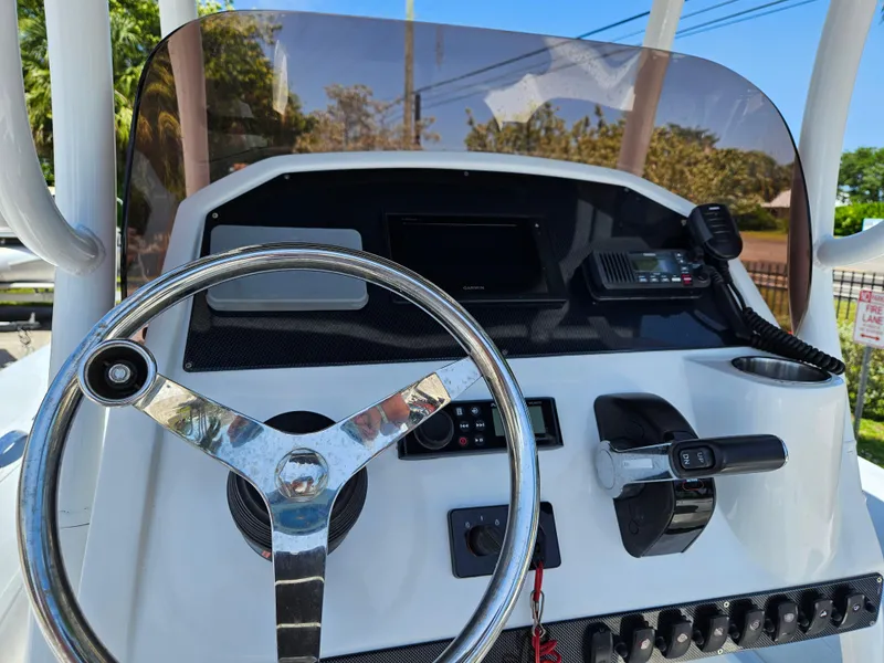 Slide: The Image of 2020 AB Inflatables Oceanus 24VST boat dashboard with steering wheel and controls. - 11