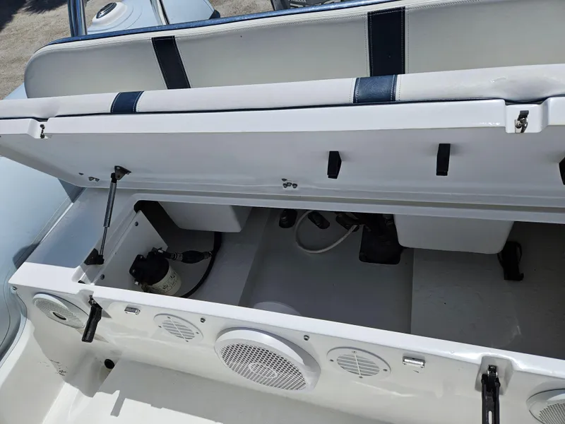 Slide: The Image of 2020 AB Inflatables Oceanus 24VST boat storage compartment with open lid and visible speakers. - 17