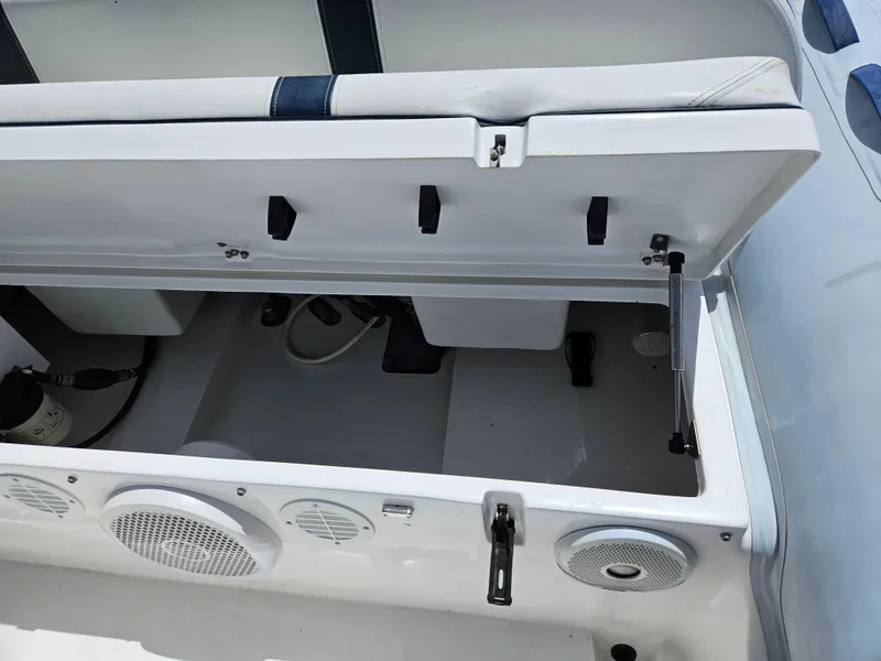 Slide: The Image of 2020 AB Inflatables Oceanus 24VST boat storage compartment with open lid and speakers. - 18
