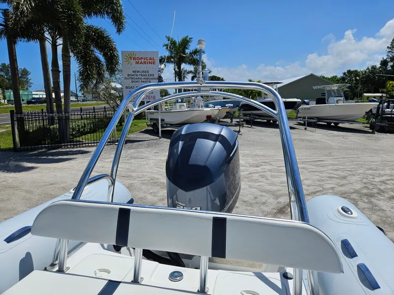 Slide: The Image of 2020 AB Inflatables Oceanus 24VST boat with outboard motor, parked outdoors under clear sky. - 8