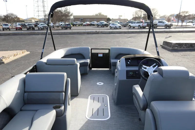 Slide: The Image of 2021 Bennington L22 pontoon boat interior with gray seating and steering console. - 11