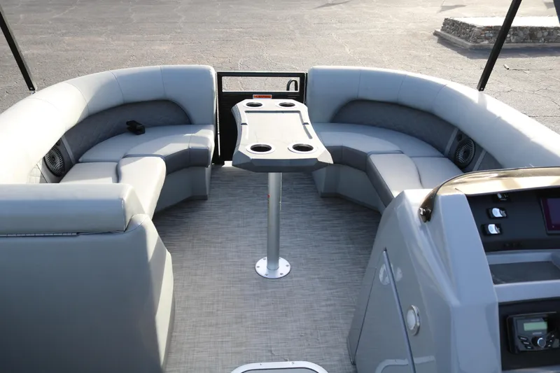 Slide: The Image of 2021 Bennington L22 pontoon boat interior with gray seating and table. - 12
