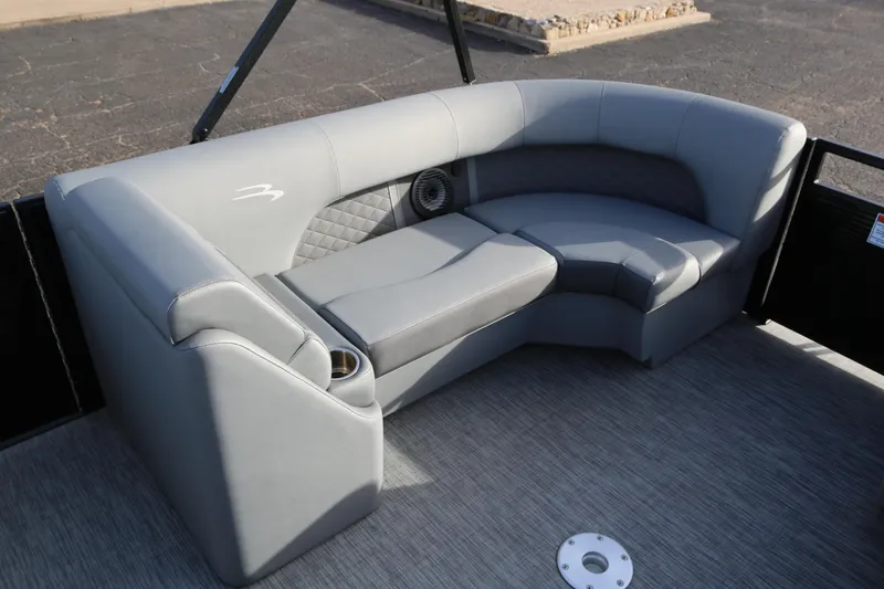Slide: The Image of 2021 Bennington L22 boat interior with gray seating and cup holders. - 13