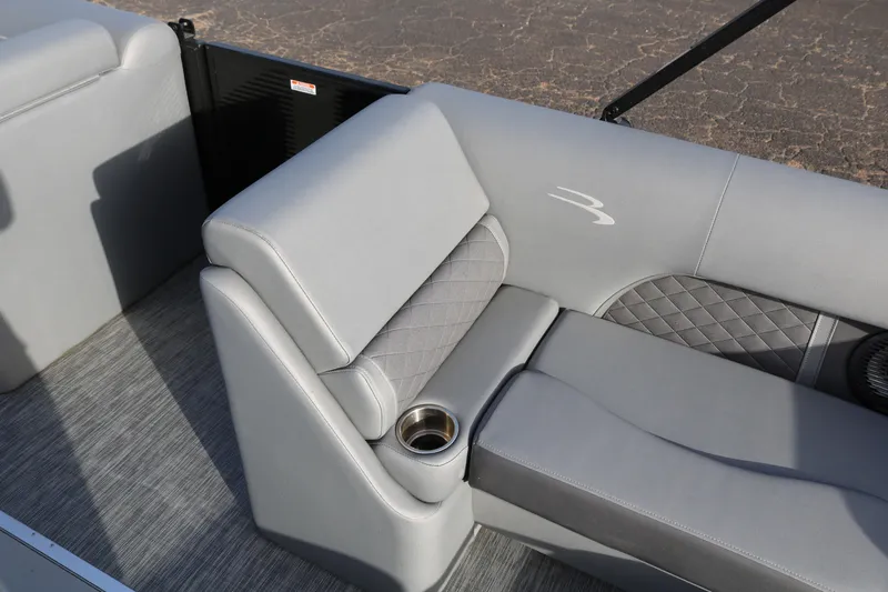 Slide: The Image of 2021 Bennington L22 boat interior with gray seating and cup holder. - 14
