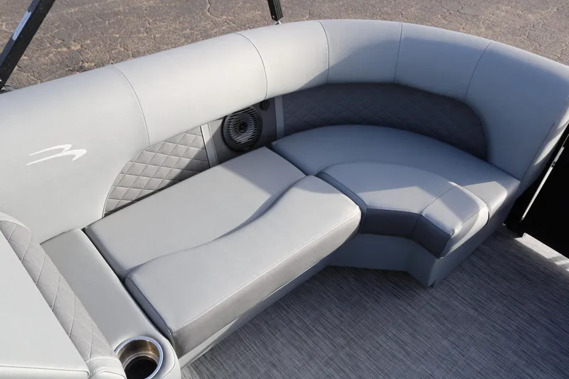 Slide: The Image of 2021 Bennington L22 boat interior with gray cushioned seating and cup holder. - 15