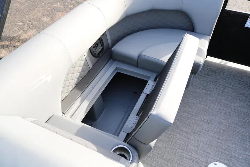 Slide: The Image of 2021 Bennington L22 boat interior with open storage compartment and cushioned seating. - 16