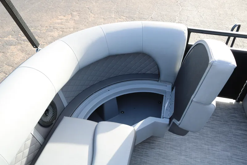 Slide: The Image of 2021 Bennington L22 boat interior with gray cushioned seating and storage compartment. - 18