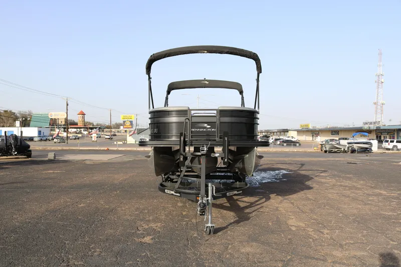 Slide: The Image of 2021 Bennington L22 pontoon boat on trailer in parking lot. - 2