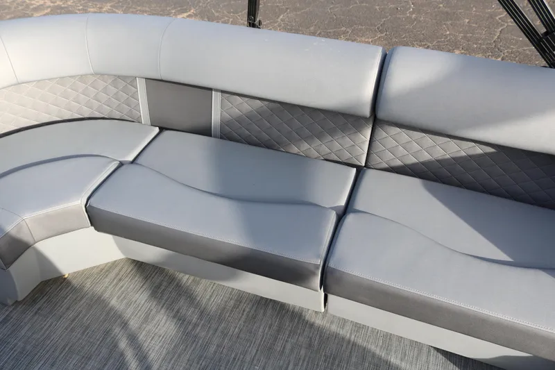 Slide: The Image of 2021 Bennington L22 boat interior with gray cushioned seating and quilted backrest design. - 20