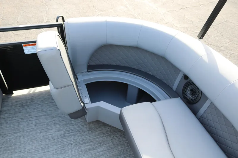 Slide: The Image of 2021 Bennington L22 boat interior with gray seating and storage compartment. - 23