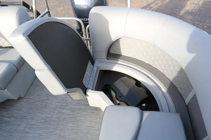 Slide: The Image of 2021 Bennington L22 boat interior with open storage compartment and cushioned seating. - 30