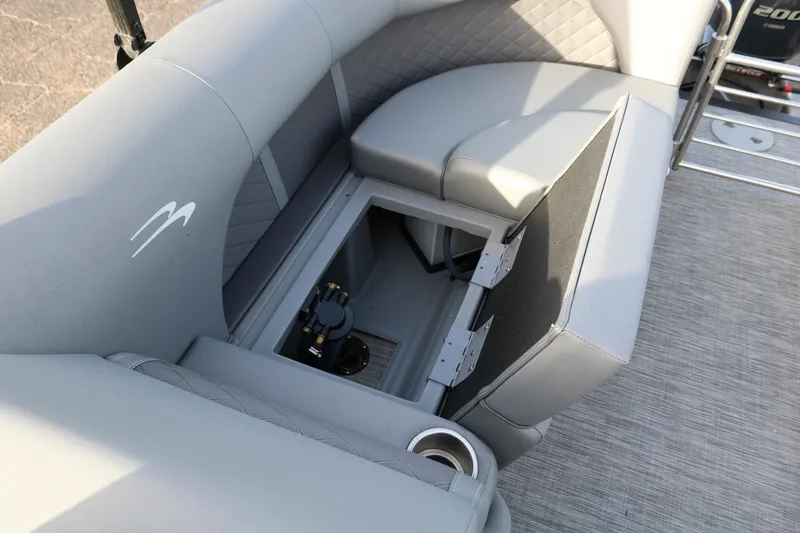 Slide: The Image of 2021 Bennington L22 boat with open storage compartment and gray seating. - 34