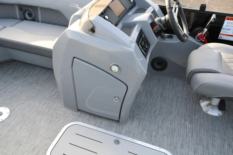 Slide: The Image of 2021 Bennington L22 boat interior with gray seating and modern dashboard. - 38